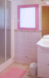 a close up of pink tub and sink and a mirror